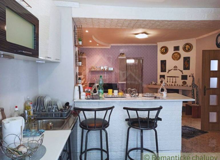 Interior of a family house: kitchen, bar stools, wall decorations.