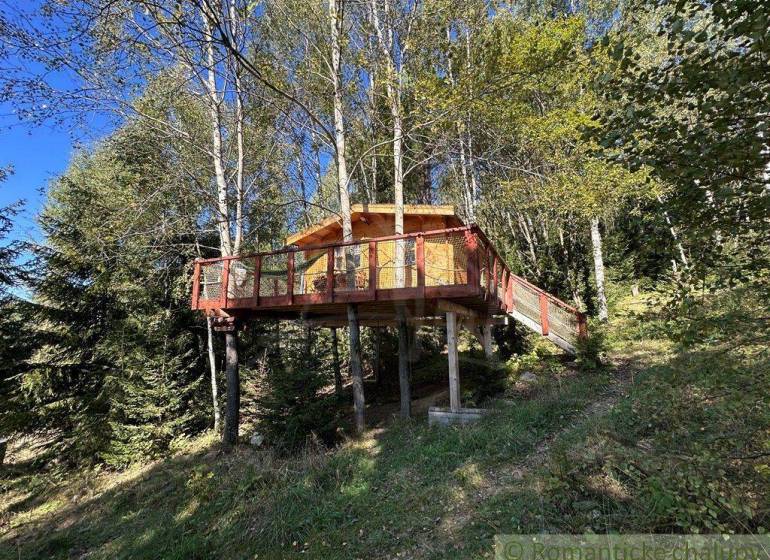A wooden treehouse in a forest setting for family getaway and relaxation.
