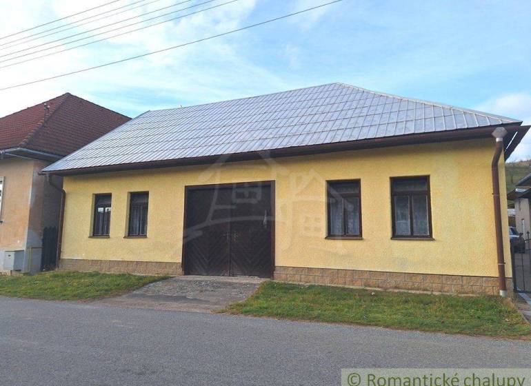 A yellow building with a metal roof, suitable for commercial spaces in a village environment.