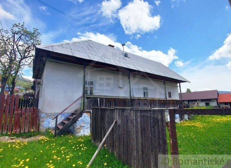 A historic house with a gabled roof and wooden fencing in a Special property.