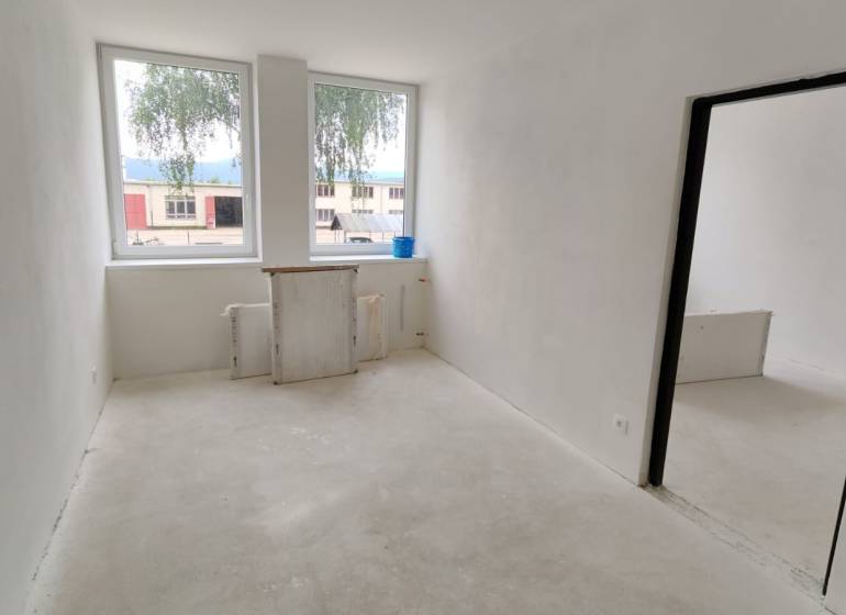 A bright room with two windows in a 3-room apartment.
