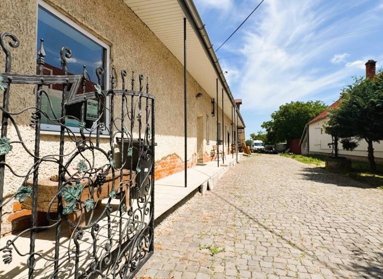 A family house on Milhostovská Street in Trebišov with a wrought iron gate and a landscaped entrance.