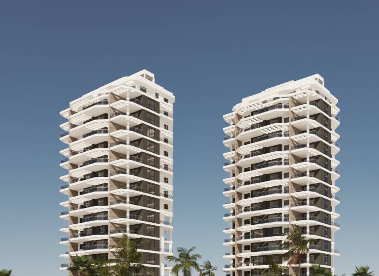 Modern residential towers in Calpe with palm trees and a blue sky, ideal for a 3-bedroom apartment.