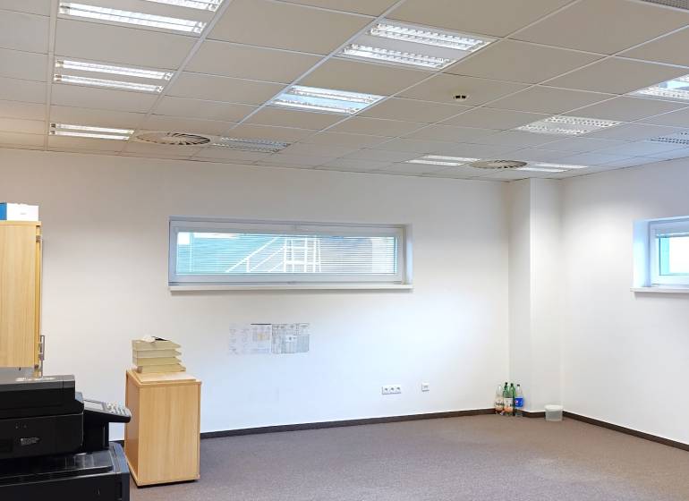Offices with white walls, a cabinet, a printer, and windows.