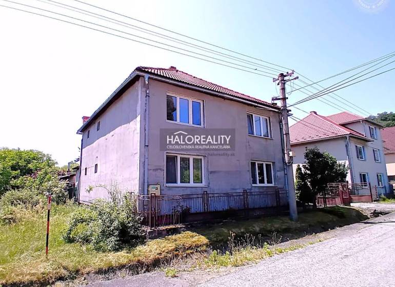 A family house in Hontianske Nemce with two floors, a sloped roof, close to the road.