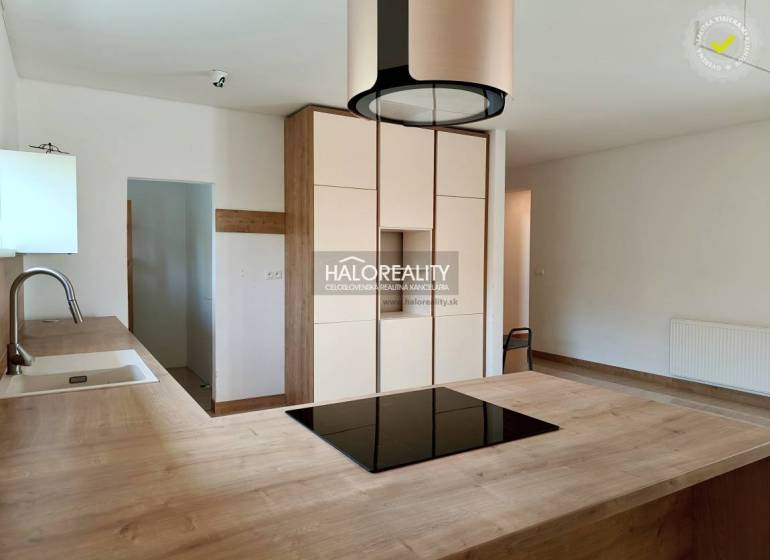A kitchen unit with wooden countertops and light cabinets in a family house.