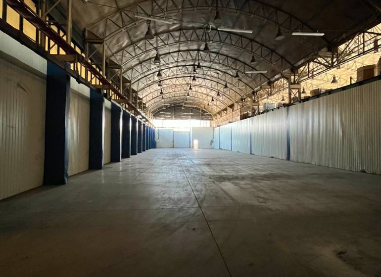 Spacious interior with an arched roof, suitable for warehouses and halls.
