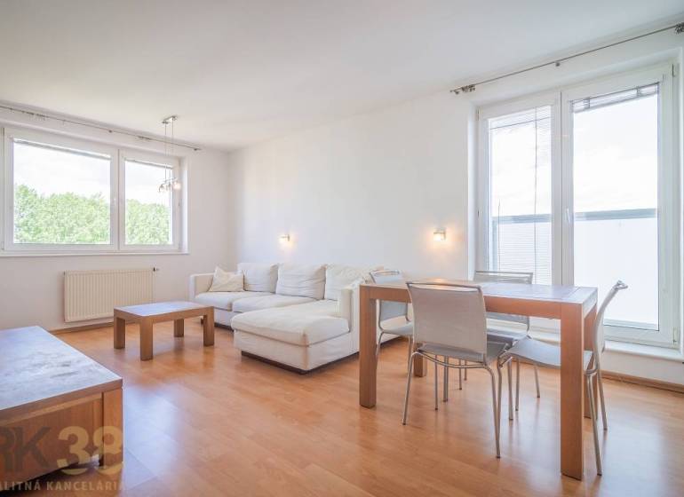 Living room in a three-room apartment with a corner sofa and wooden furniture.