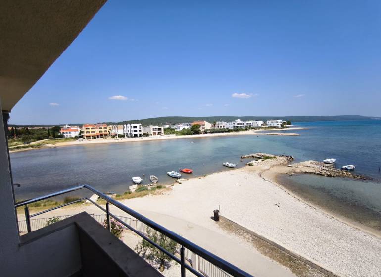 View from a studio apartment in Sukošan with a beach and coastline on the horizon.