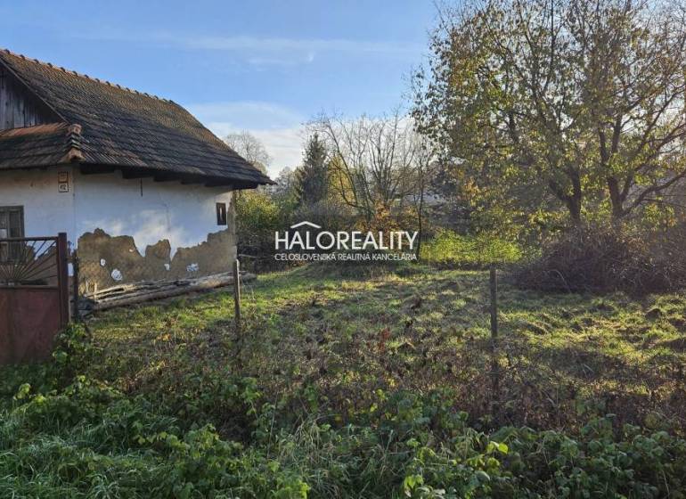 An older house for renovation, surrounded by greenery, suitable for land - living.