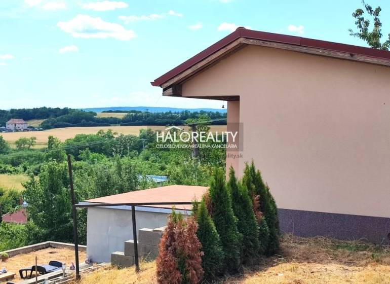 Gardens in Lučenec with a scenery of a rural environment and buildings in the distance.