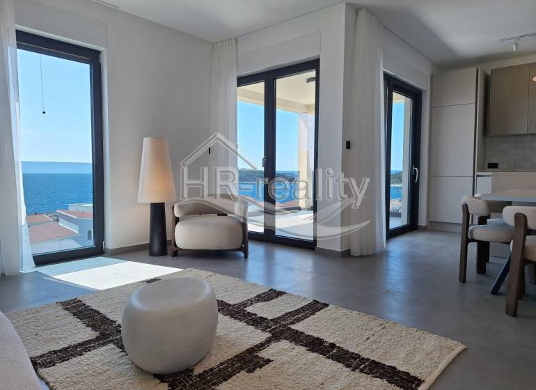 A bright interior of a holiday apartment with a sea view and comfortable seating.