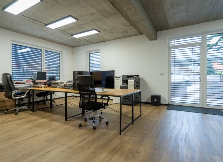 Offices with wooden floors, work desks, and comfortable chairs.