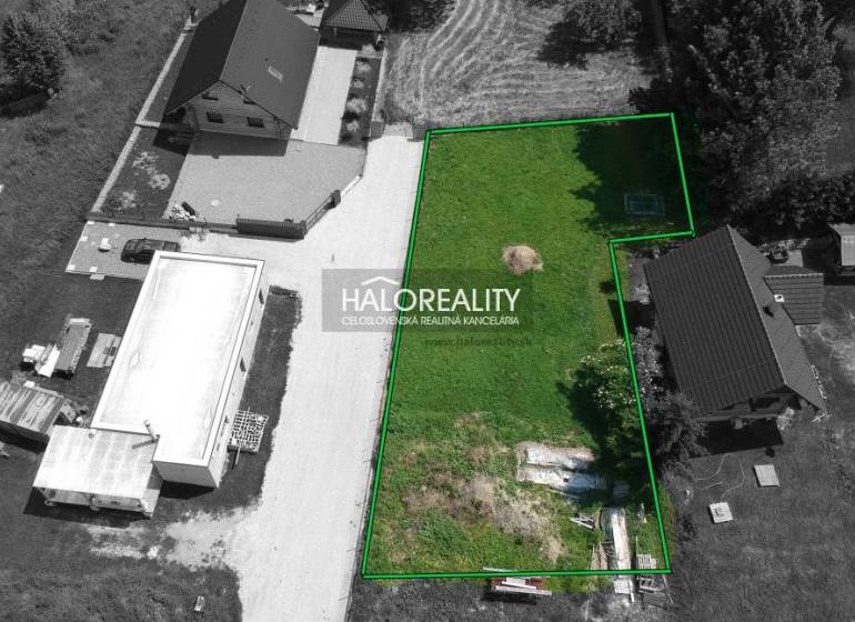 A view of a plot of land in Malatíny suitable for living, with surroundings and access road.