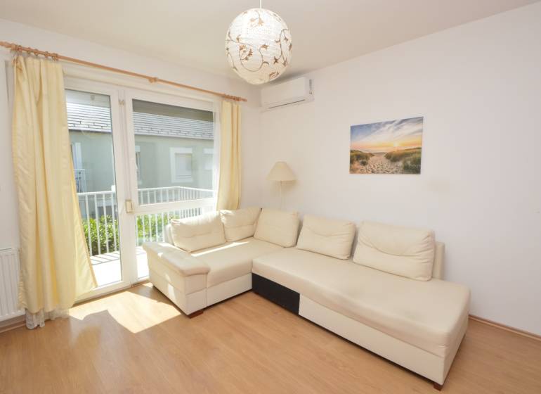 Bright living room with a white sofa in a 2-room apartment.