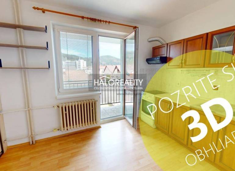 Studio apartment with a practical kitchen, wooden cabinets, and a large window to let in natural light.