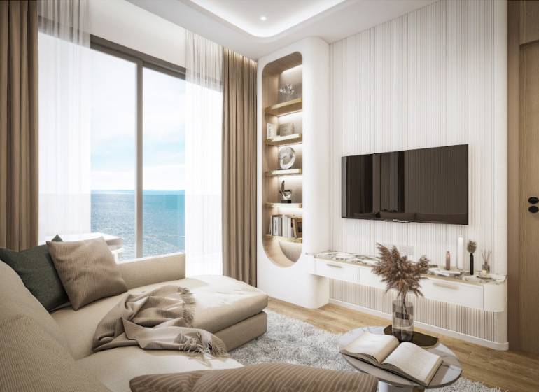 Living room in a 3-room apartment with a sea view, comfortable sofa, TV on the wall.