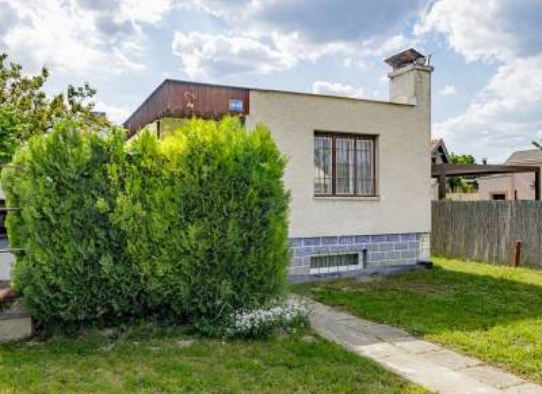 A family house on Mokráň záhon Street in Bratislava-Ružinov, surrounded by greenery and lawn.