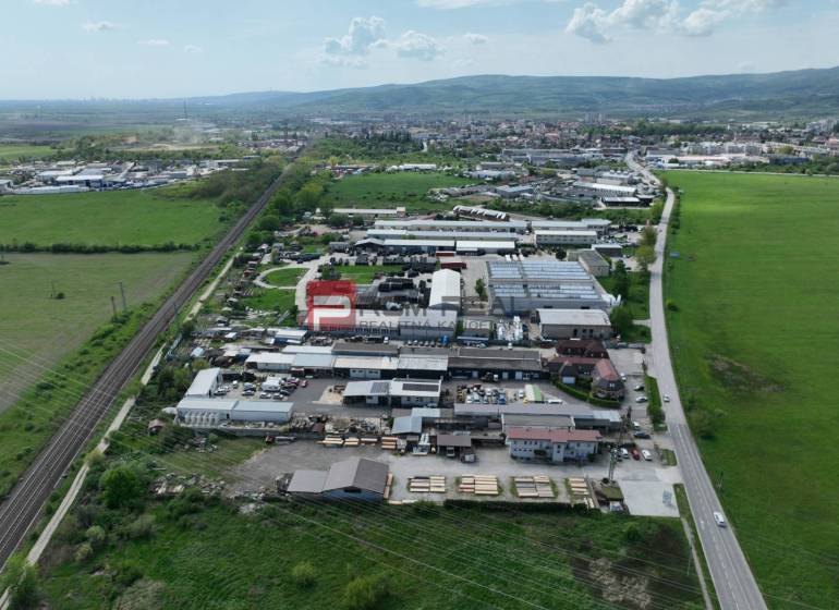 Aerial view of commercial premises on Šenkvická Road in Pezinok surrounded by nature.