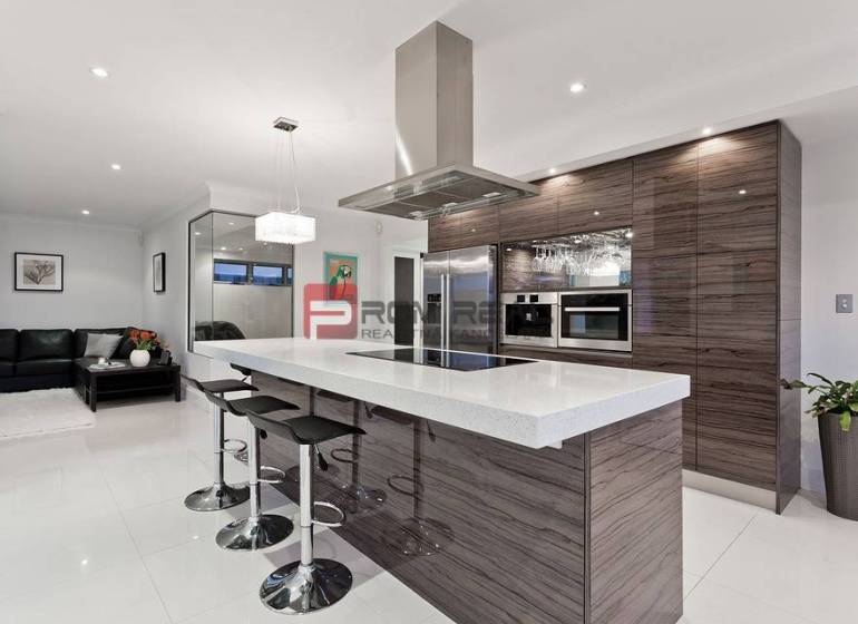 Modern kitchen with an island in a 3-room apartment. Elegant solution with bar stools.