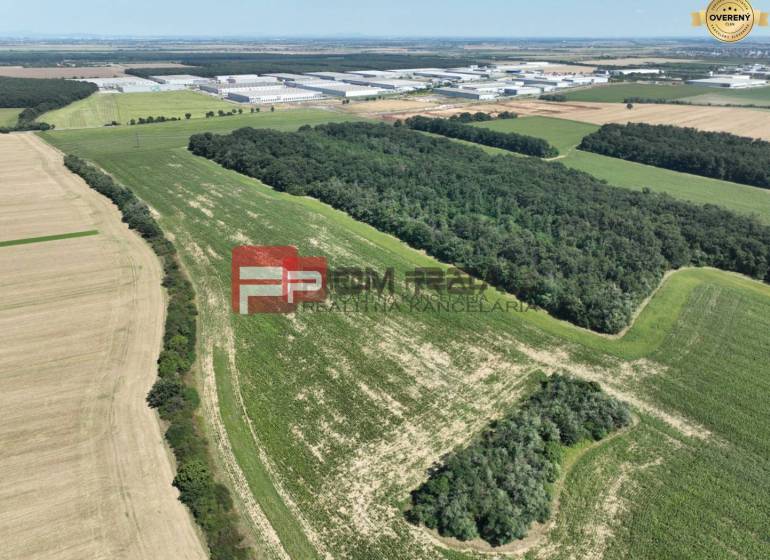 Aerial view of agricultural and forest land near Senecká Street and buildings.