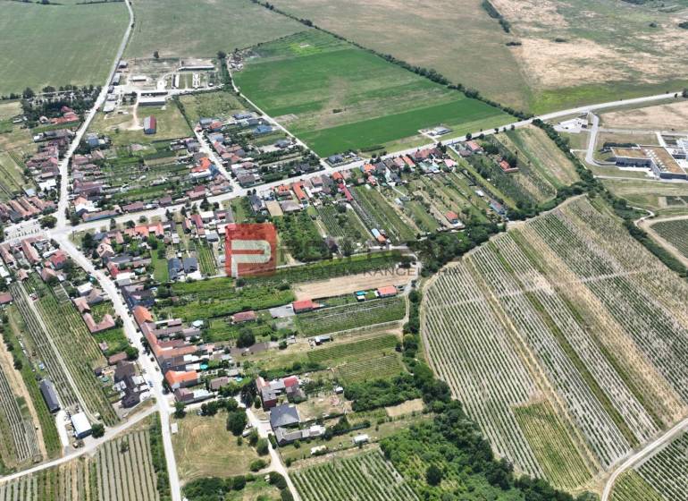 Aerial view of Dubová, organized streets and surrounding fields, plots - housing.