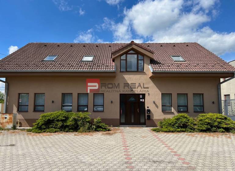 Production premises on Nová Street in Pezinok with a large paved area in front of the building.