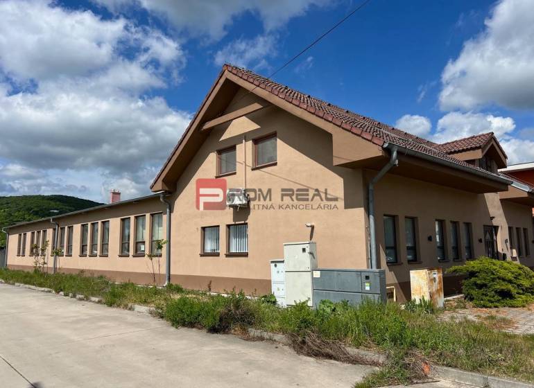 Production premises on Nová Street in Bratislava III, with a blue sky and greenery.