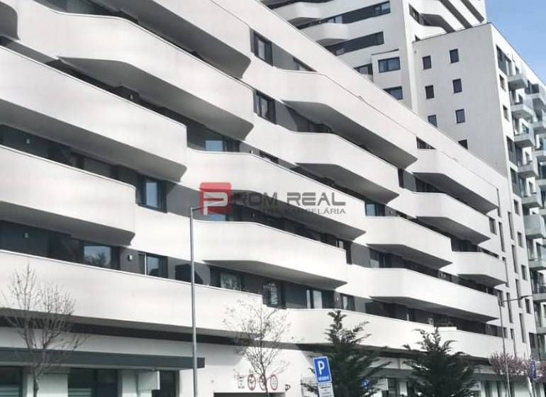 A building with balconies on Údernícka Street in Bratislava V, garages in the foreground.