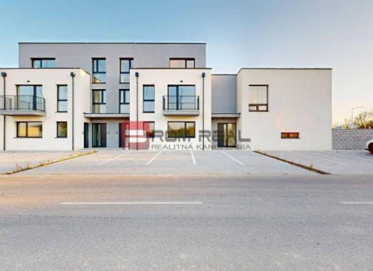 Building on Bottova Street, modern architecture, parking lot, and family house in the background.