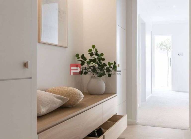 Entrance hallway with wooden furniture, a vase, and shelves, ideal for a holiday apartment.