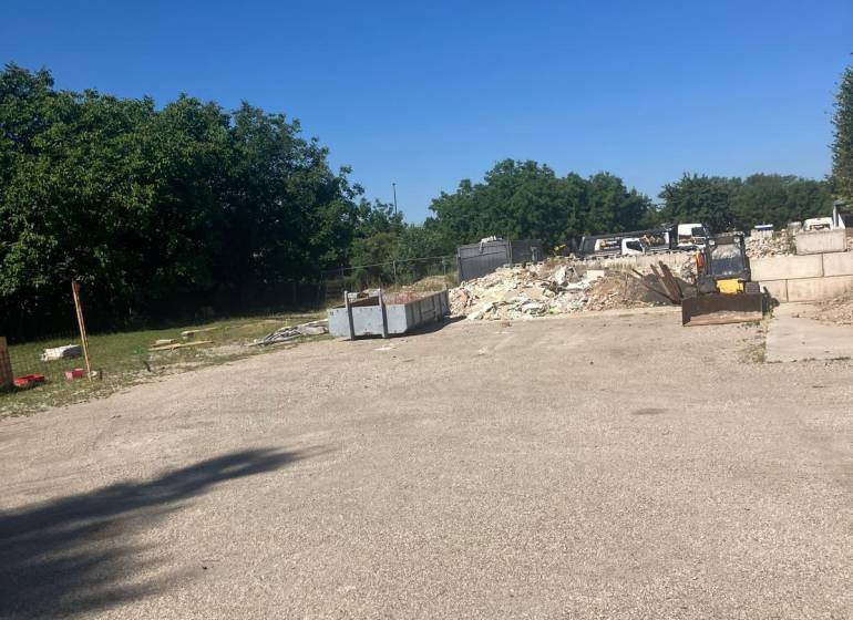 A construction site with containers and construction waste on commercial land on Popradská in Bratislava - Podunajské Biskupice.