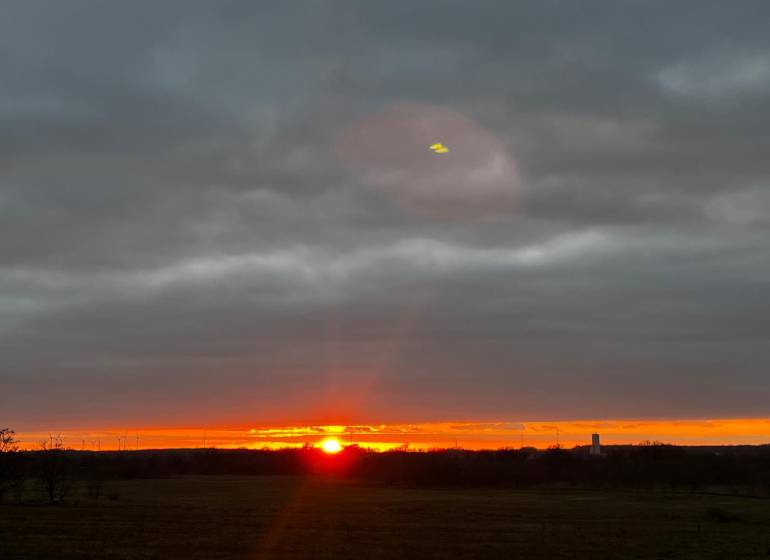 Sunset in Bratislava - Devínska Nová Ves with wind turbines on the horizon.