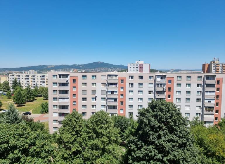 A view of apartment buildings in Nitra on Petzwalova Street, with a view of the surrounding nature.
