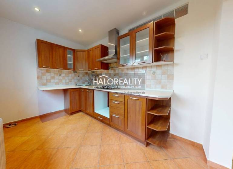 A kitchen in a 3-room apartment with a wooden cabinet and ceramic tiles.