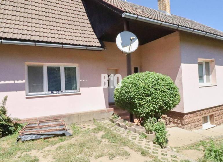 A family house in Podhradie with a satellite dish and landscaped outdoor area.