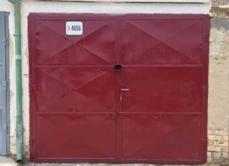 Red garage door on Michalovská Street, Košice - Západ district.
