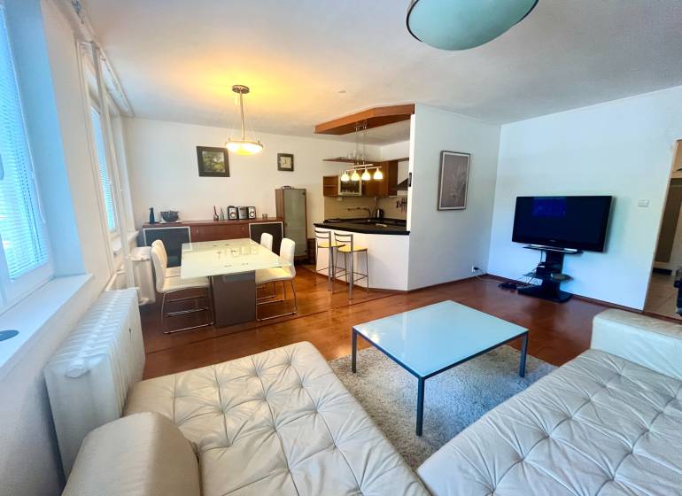 Living room with kitchen in a 3-room apartment, equipment includes a sofa, table, and television.