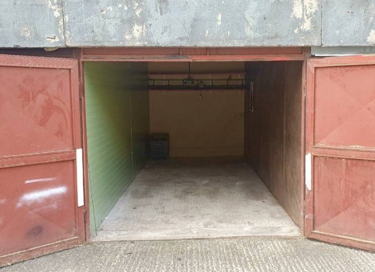 Open garage door on Dudvážska Street in Bratislava - Podunajské Biskupice, view inside.