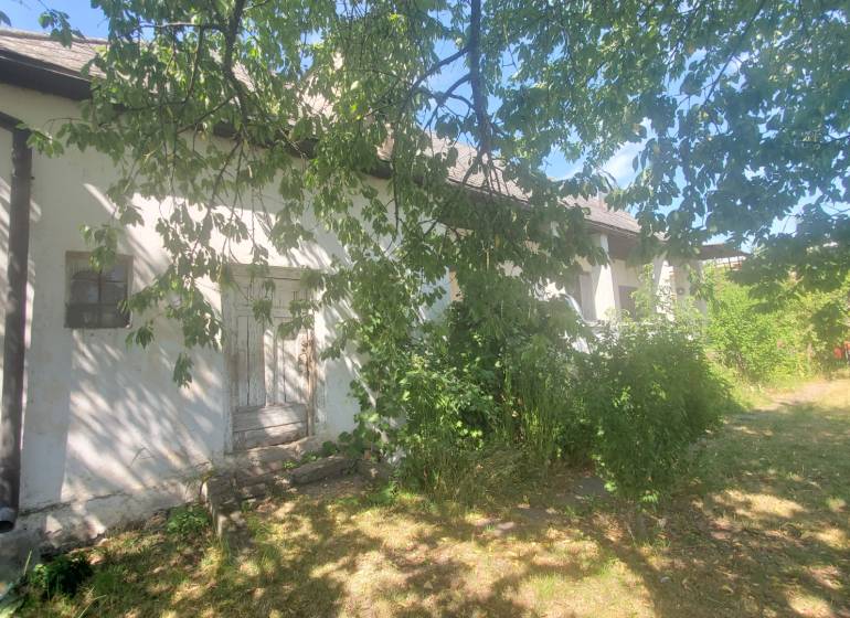 A family house on Mostová Street in Sečovce, surrounded by greenery and trees.