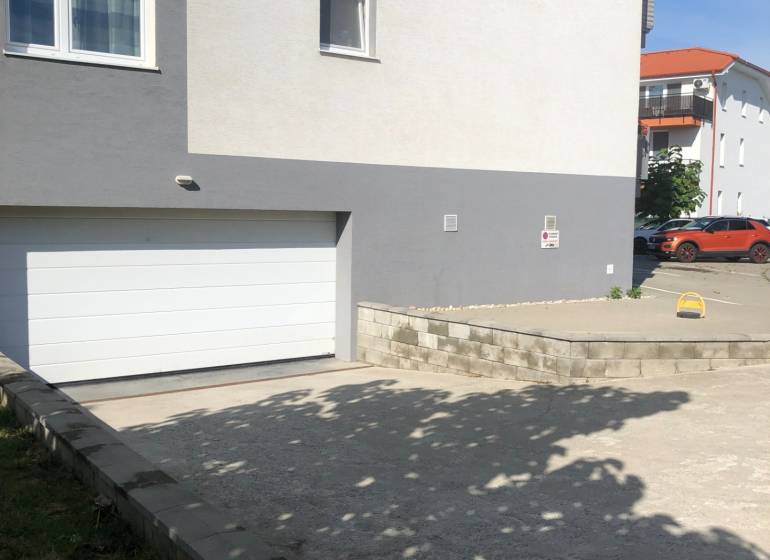 In Slovenský Grob on Rastislavova Street, there are garages near residential buildings.