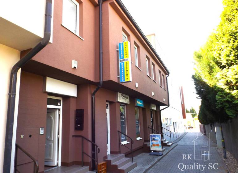 Building on Mäsiarska Street in Senec with stairs and advertising boards.