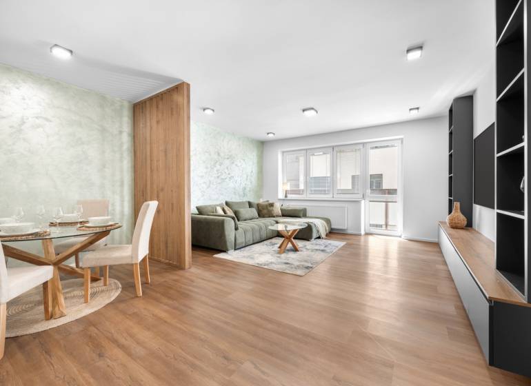 Living room in a 3-room apartment with a sofa, dining table, and modern furniture.
