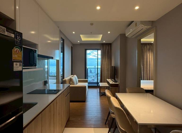 Kitchen and dining room in a 3-room apartment with a view from the balcony.