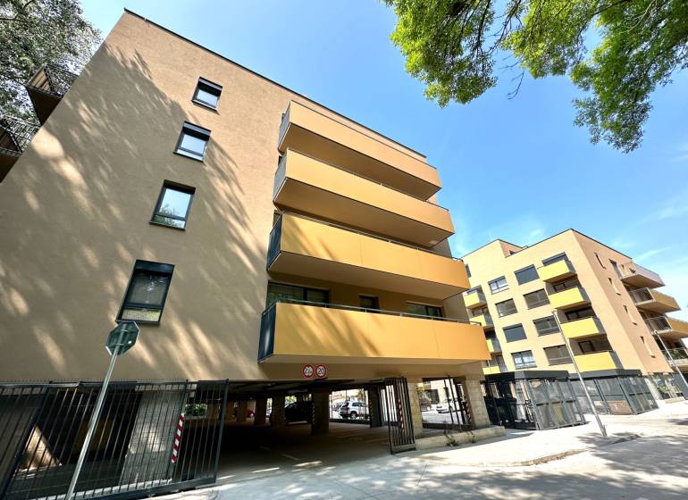 Apartment complex with glass balconies, garages in Senica on Sadová Street.