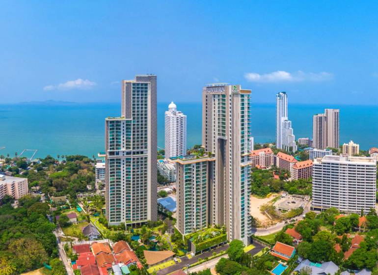 Apartment construction in Pattaya, high-rise buildings by the coast with a sea view.