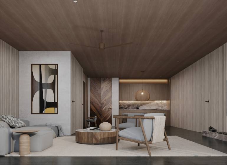 Interior of a family house with a sofa, armchairs, and artwork on the wall.