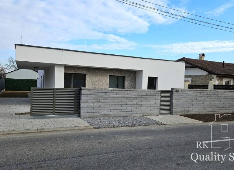A family house in the village of Tureň with modern architecture and a stone facade.
