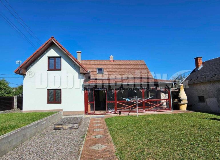 A family house in Malá Lehota with a gable roof and a landscaped garden.