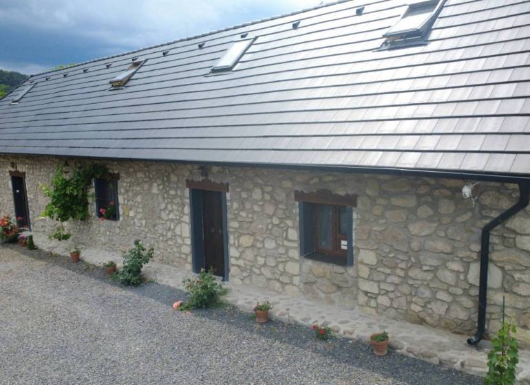 Stone family house in BOLDOGKOVARALJA with windows and a sloped roof.